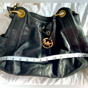 Black leather Michael Kors drawstring bag